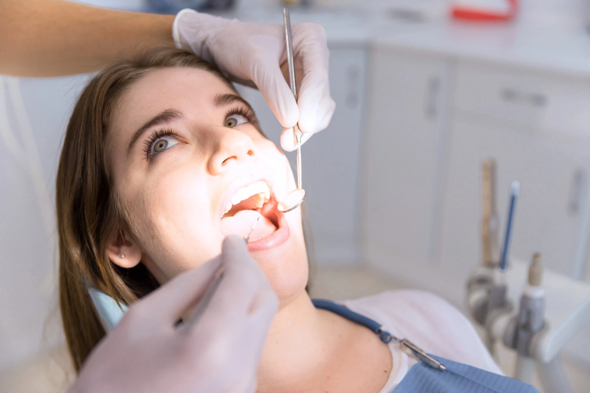 Female patient being examined for tooth extraction