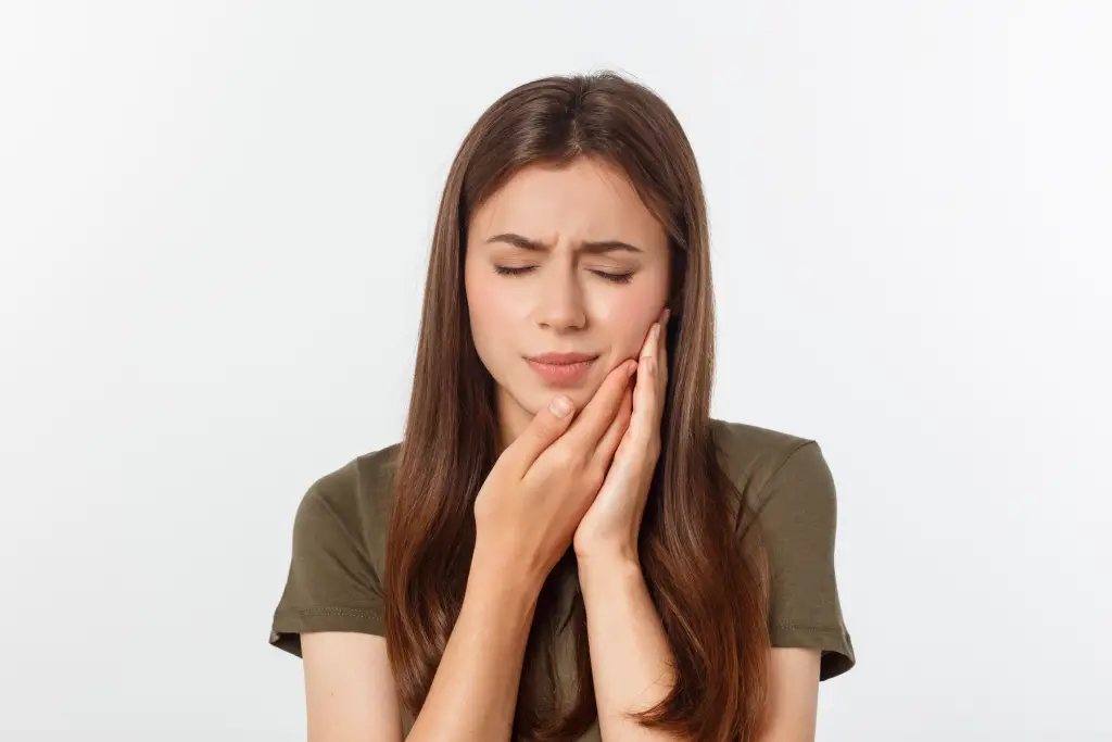 Patient with dental emergency holding jaw needing same-day care in Fairfield CA | Dental Emergencies Fairfield