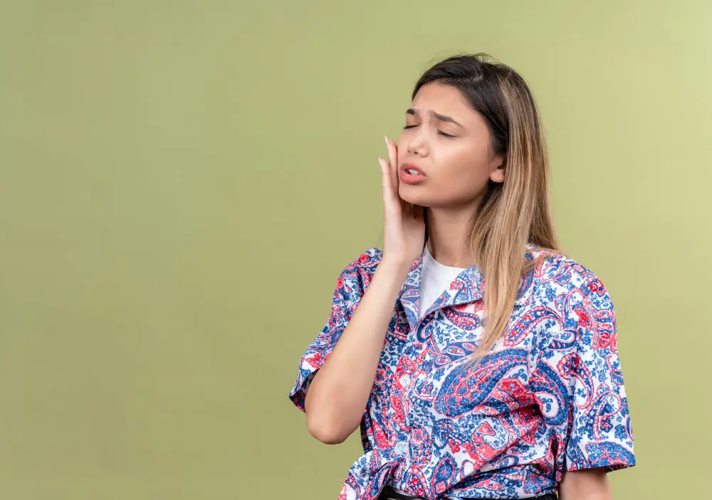 Patient holding jaw in pain needing emergency dental evaluation in Fairfield CA